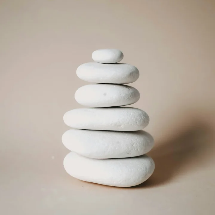 Smooth pale stones stacked on a warm background